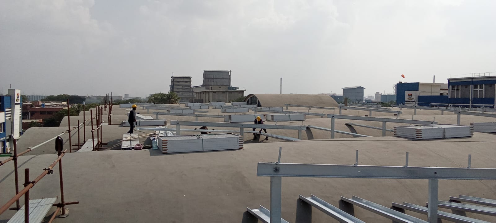 Module Staging — Panel crates staged for installation across the roof structure