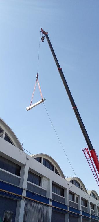 Structural Member Lifting — Mobile crane placing a fabricated steel member to roof level
